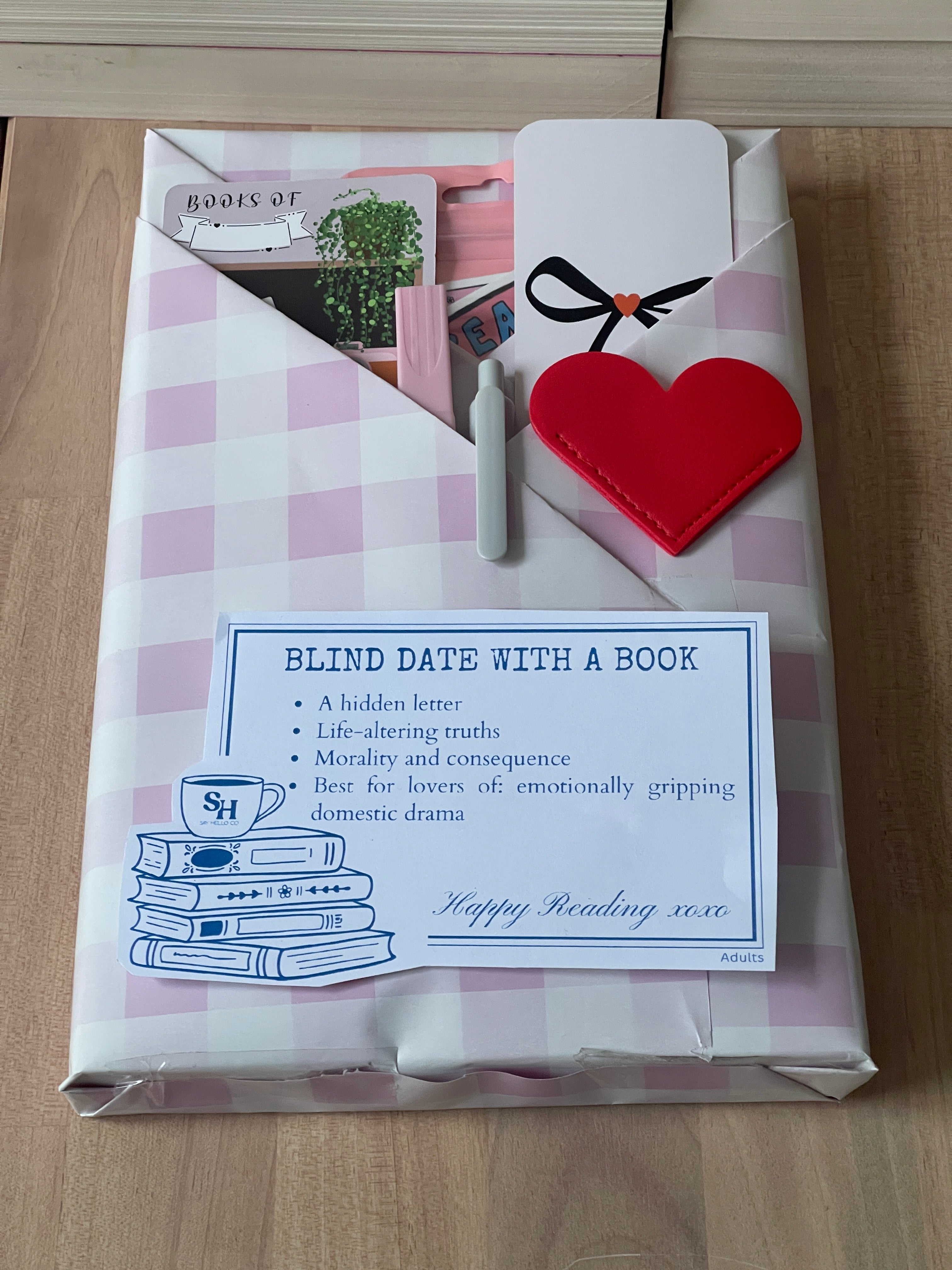 Packaged product with a heart-shaped item and card on a wooden surface