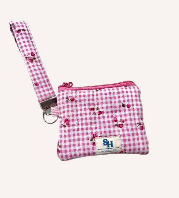 Pink gingham check with miniature strawberries pouch with a strap on a warm cream background
