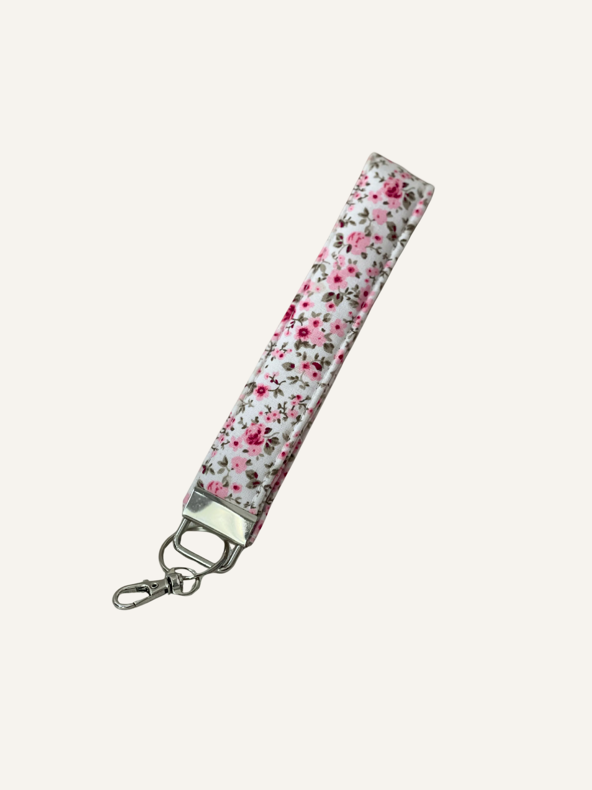 pink and cream Floral patterned keychain strap on a warm cream background